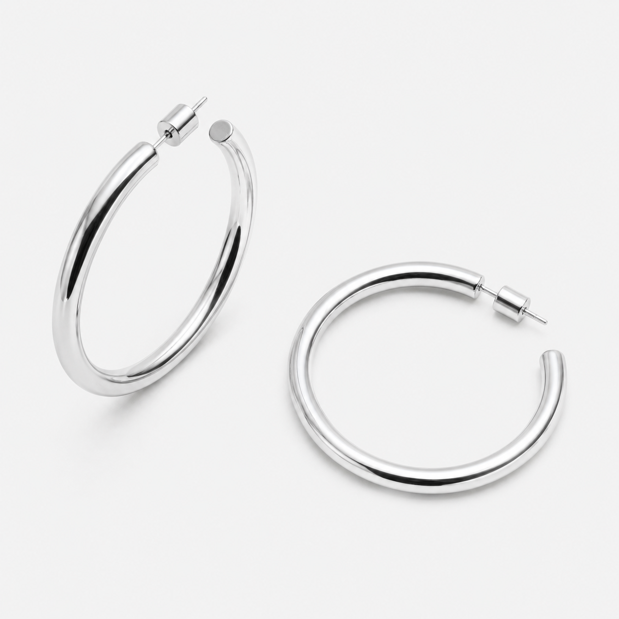 Bonheur Jewelry Madison Tube Hoops, gold, rose gold, or rhodium finish, polished metal, hoop earrings, front view.