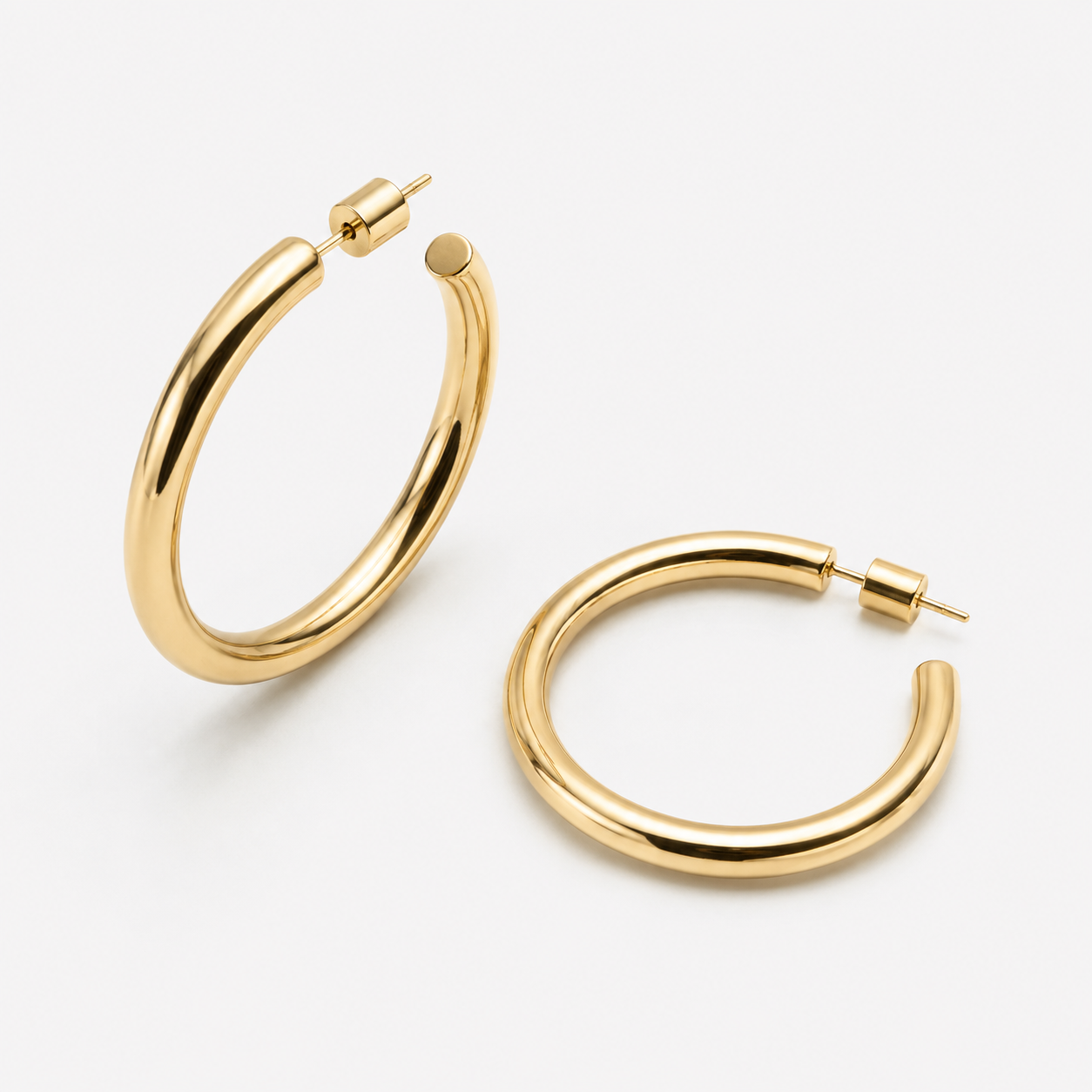 Bonheur Jewelry Madison Tube Hoops, gold, rose gold, or rhodium finish, polished metal, hoop earrings, front view.