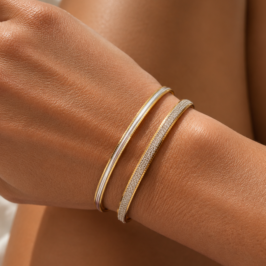 Bonheur Jewelry Cassie Diamond-Cut Gold Bracelet, reflective two tone gold bracelet with diamond-cut herringbone texture, styled view.