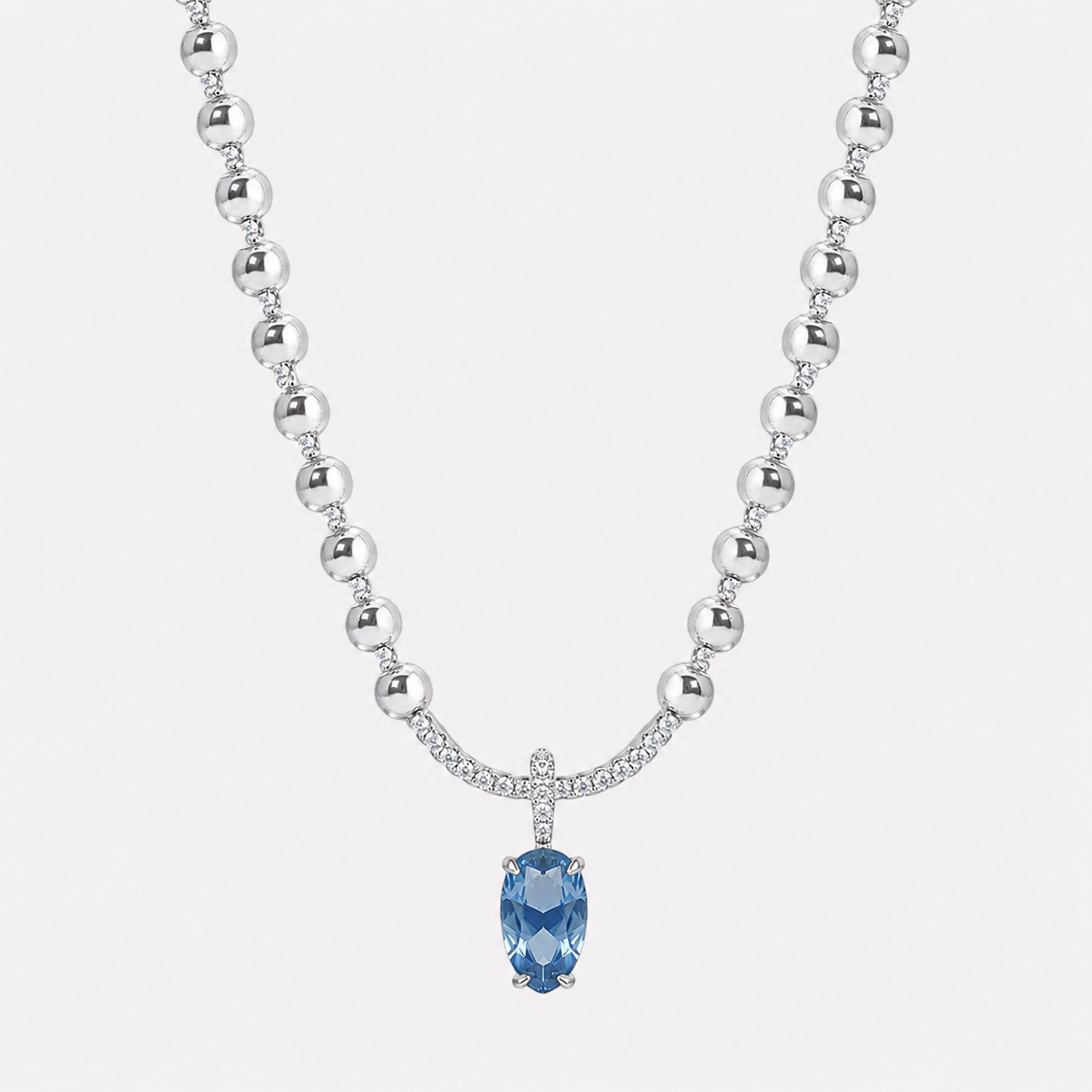 Bonheur Jewelry Coralie Pear Pendant Necklace, gold/rhodium finish, blue Swarovski crystal necklace, product detail.