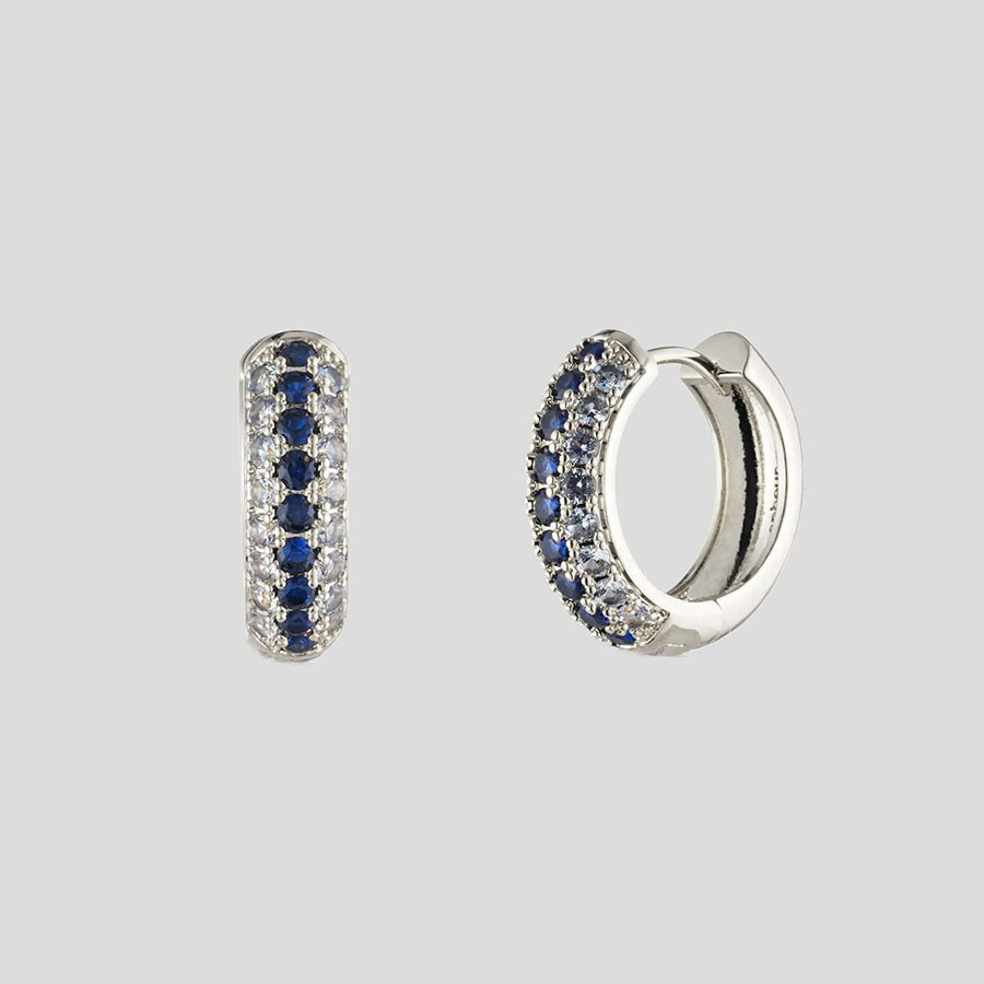 Bonheur Jewelry Addison Pave Huggie Hoop Earrings, gold/rhodium finish, blue crystal, hoop earrings, detail view.