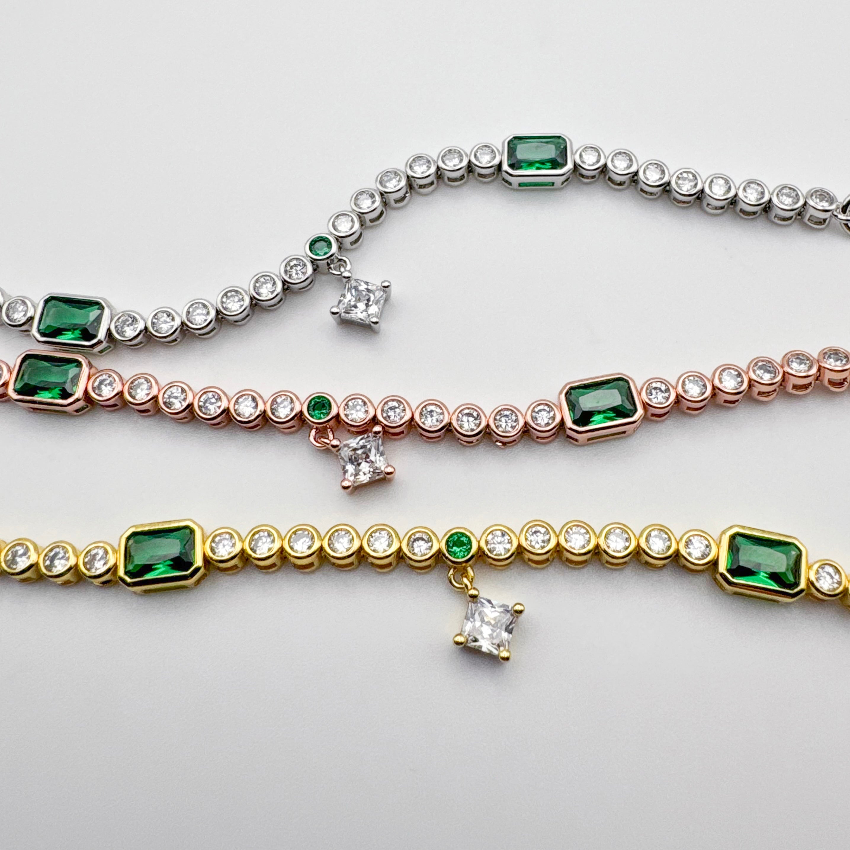 Bonheur Jewelry Eugenié Bezel Tennis Bracelet in gold or rhodium finish with white and green Swarovski crystals, side view.