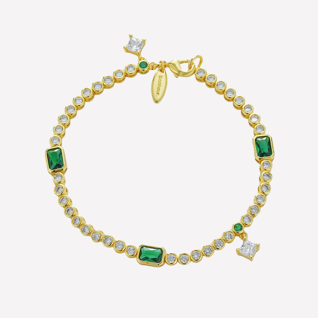 Bonheur Jewelry Eugenié Bezel Tennis Bracelet in gold or rhodium finish with white and green Swarovski crystals, front view.