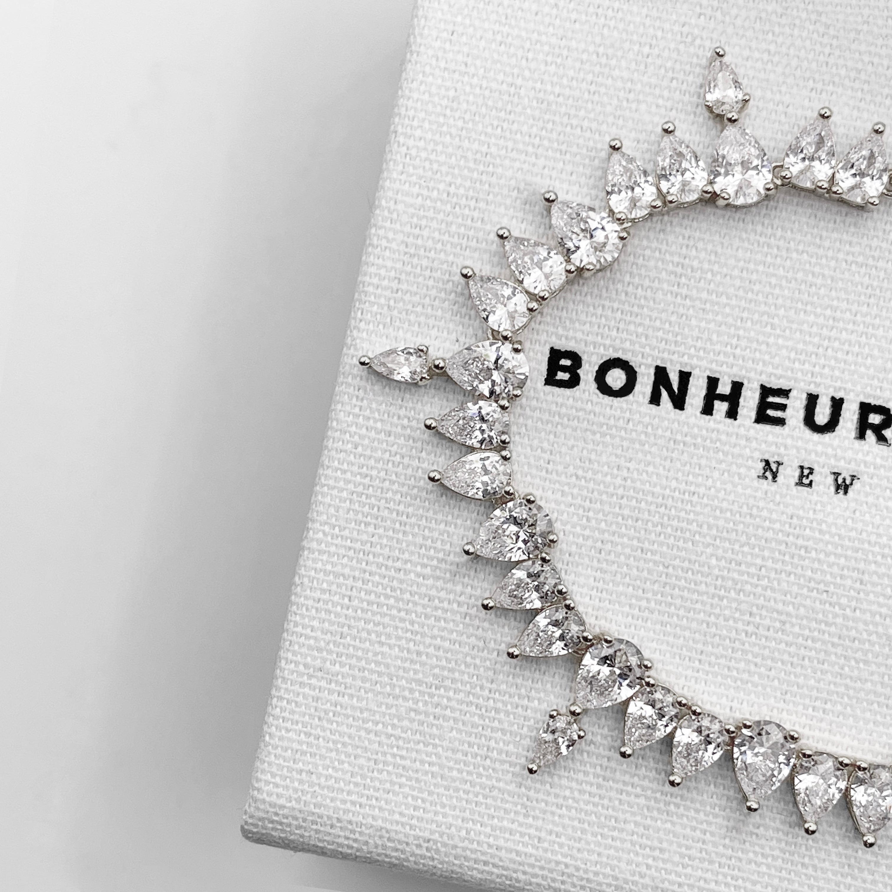 Bonheur Jewelry Roxane Pear Tennis Bracelet, pear cut tennis bracelet with white Swarovski crystals in gold or rhodium finish, detail view.