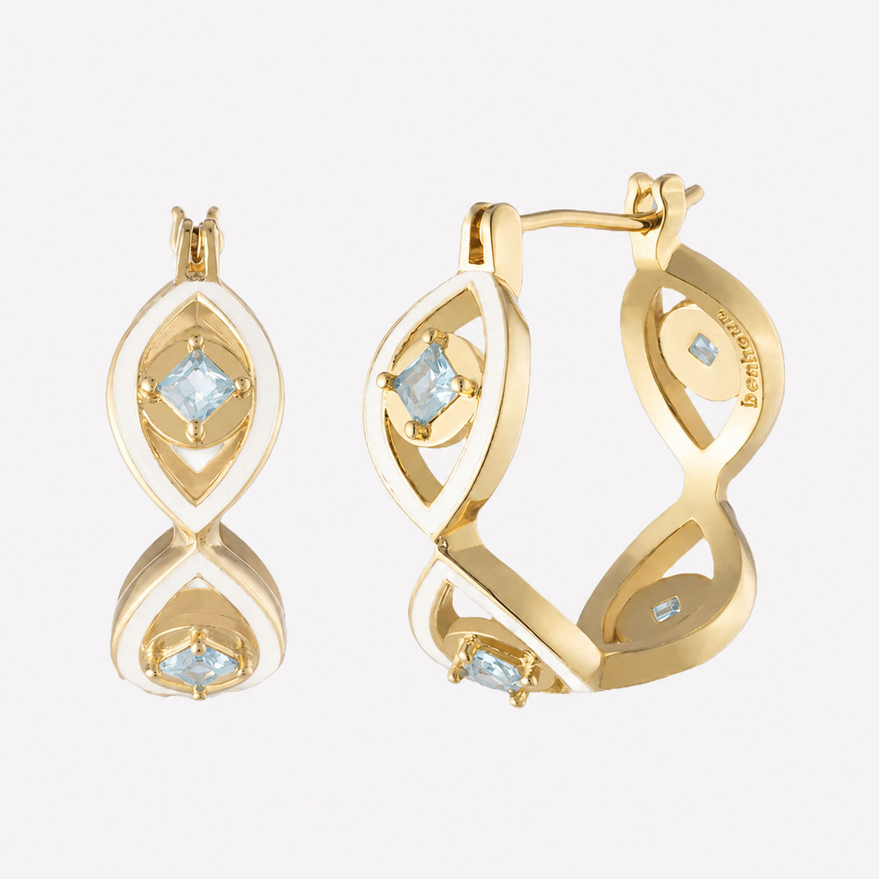 Shiva white enamel hoop earrings with gold plated hoops and blue Swarovski crystal centers.